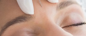 Woman recieving botox injection in forehead
