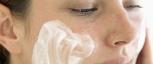 Young Woman Using Facial Cream