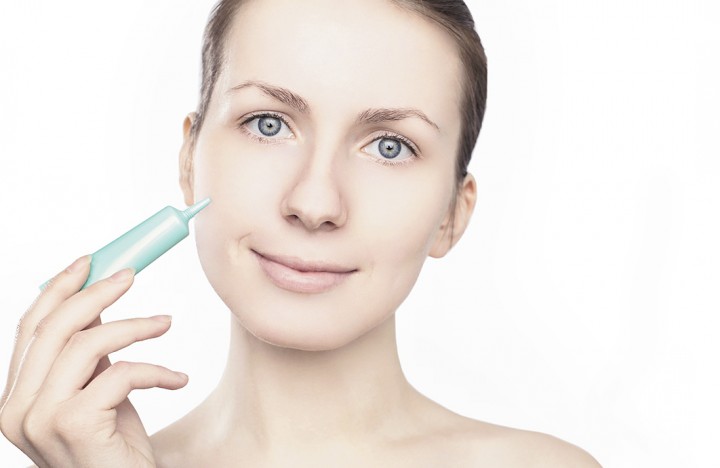 Woman applying cream, beauty, health skin - concept